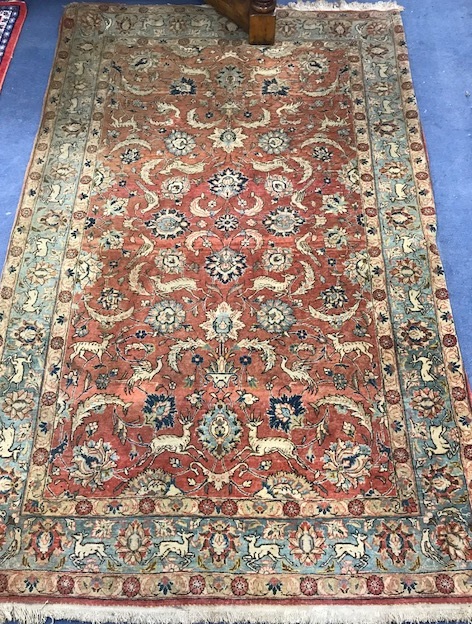 A Persian Red ground rug 220 x 138cm